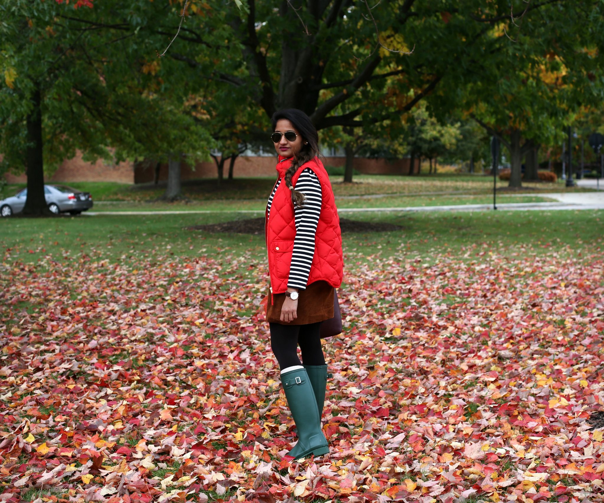 Lifestyle Blogger Surekha of Dreaming Loud Wearing Suede skirt and red puffer vest