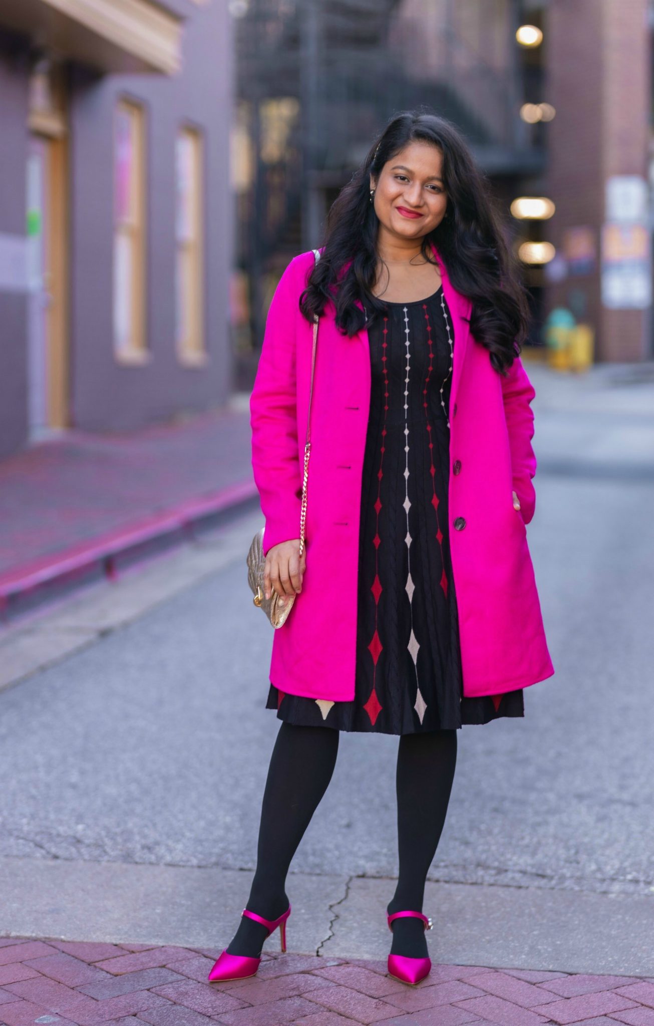 5 Cute Christmas Party Outfits by popular Maryland modest fashion blog, Dreaming Loud: image of a woman wearing Banana Republic topcoat in Hit pink,DANNY AND NICOLE diamond sweater dress,Fuchsia Pink Satin pumps, Rebecca minkoff Edie Chain Wallet.