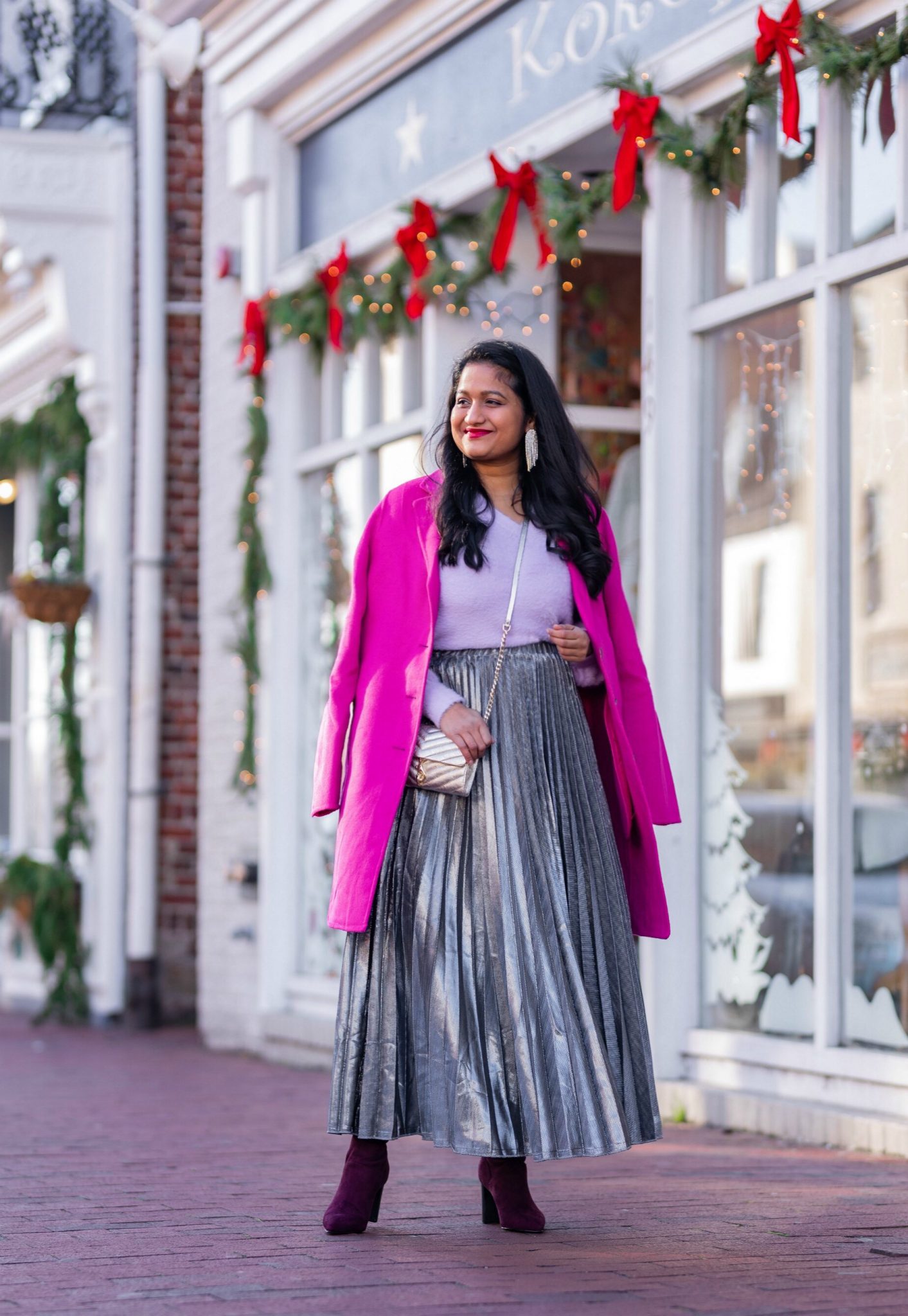 Amazon Holiday Fashion Favorites Under $50, featured by top US modest fashion blog, Dreaming Loud: image of a woman wearing Halogen Fuzzy V-Neck Sweater, amazon Silver pleated midi skirt,Banana Republic Topcoat in hot pink, Boden Burgundy knee high boots