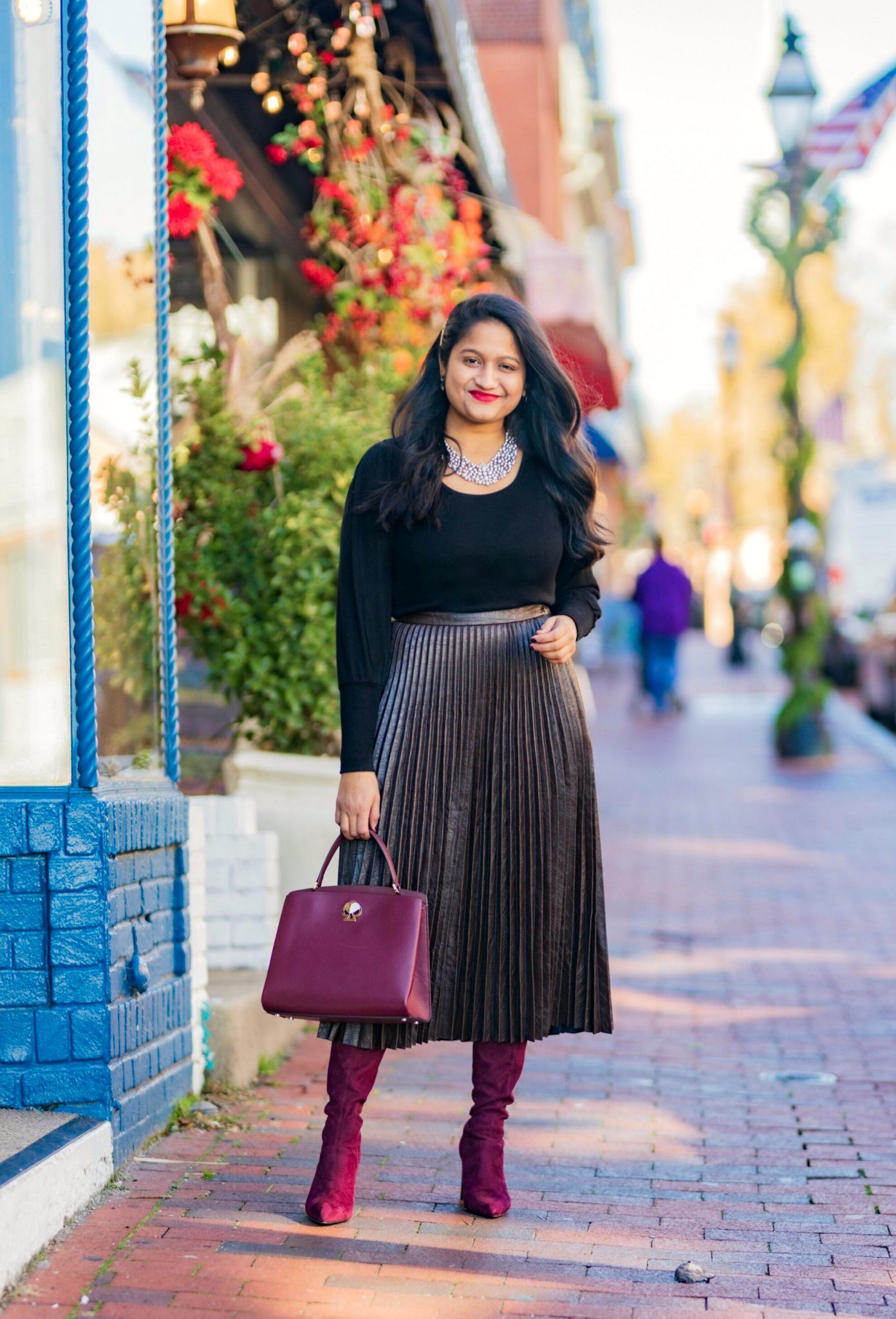 5 Cute Christmas Party Outfits by popular Maryland modest fashion blog, Dreaming Loud: image of a woman wearing and other stories A-Line Wool Blend Belted Coat, Madewell Puff-Sleeve Scoopneck Top,Atlantic-Pacific Pleated Croc Faux Leather Midi Skirt, burgundy knee high boots.