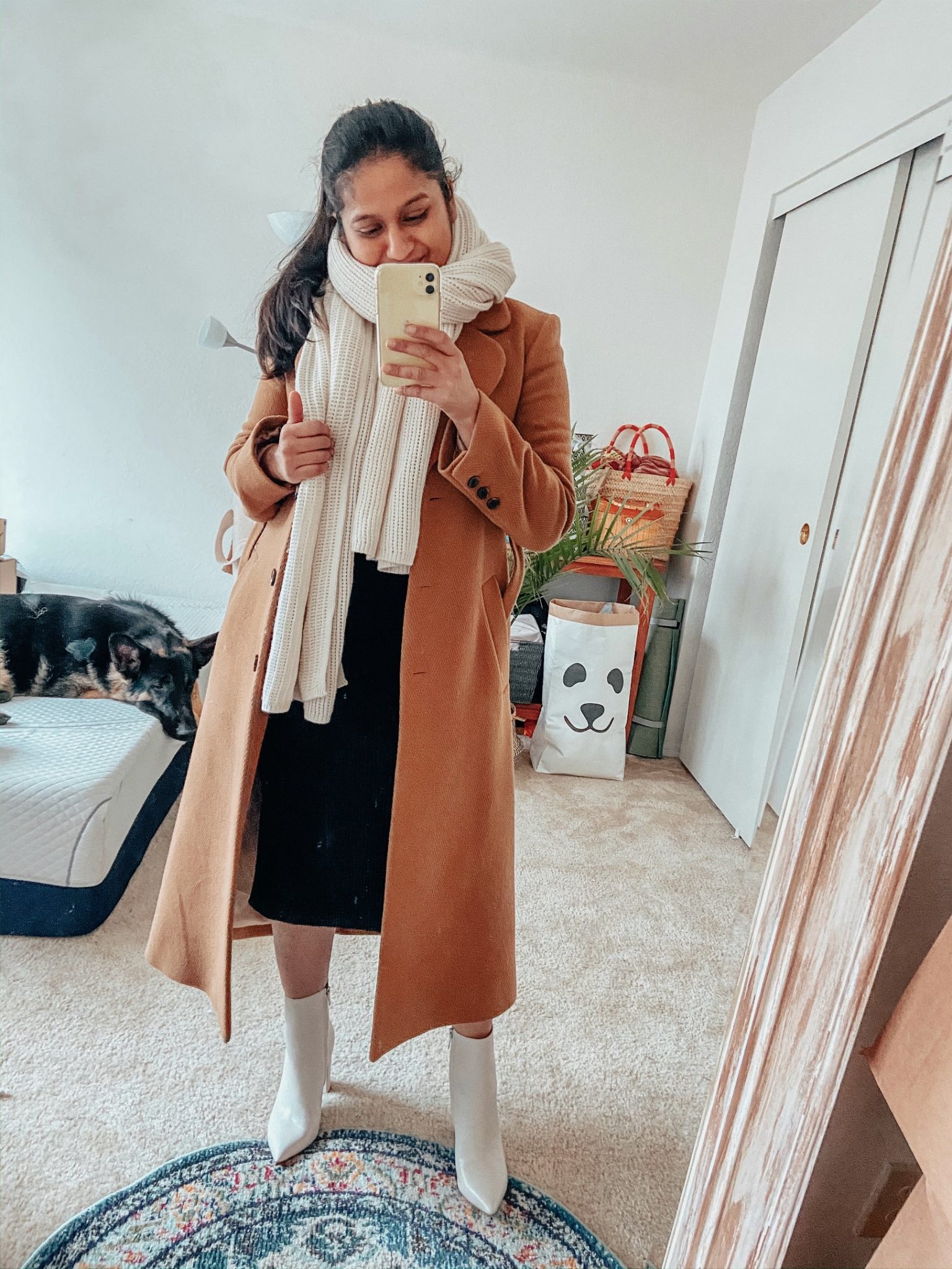 Camel Coat Outfits for Work styled by top US modest fashion blog, Dreaming Loud: image of a woman wearing Amazon fashion Lark and ro sweater dress, and other stories A-line camel coat, Club monaco cashmere scarf, Marc fisher Ulani boots in white