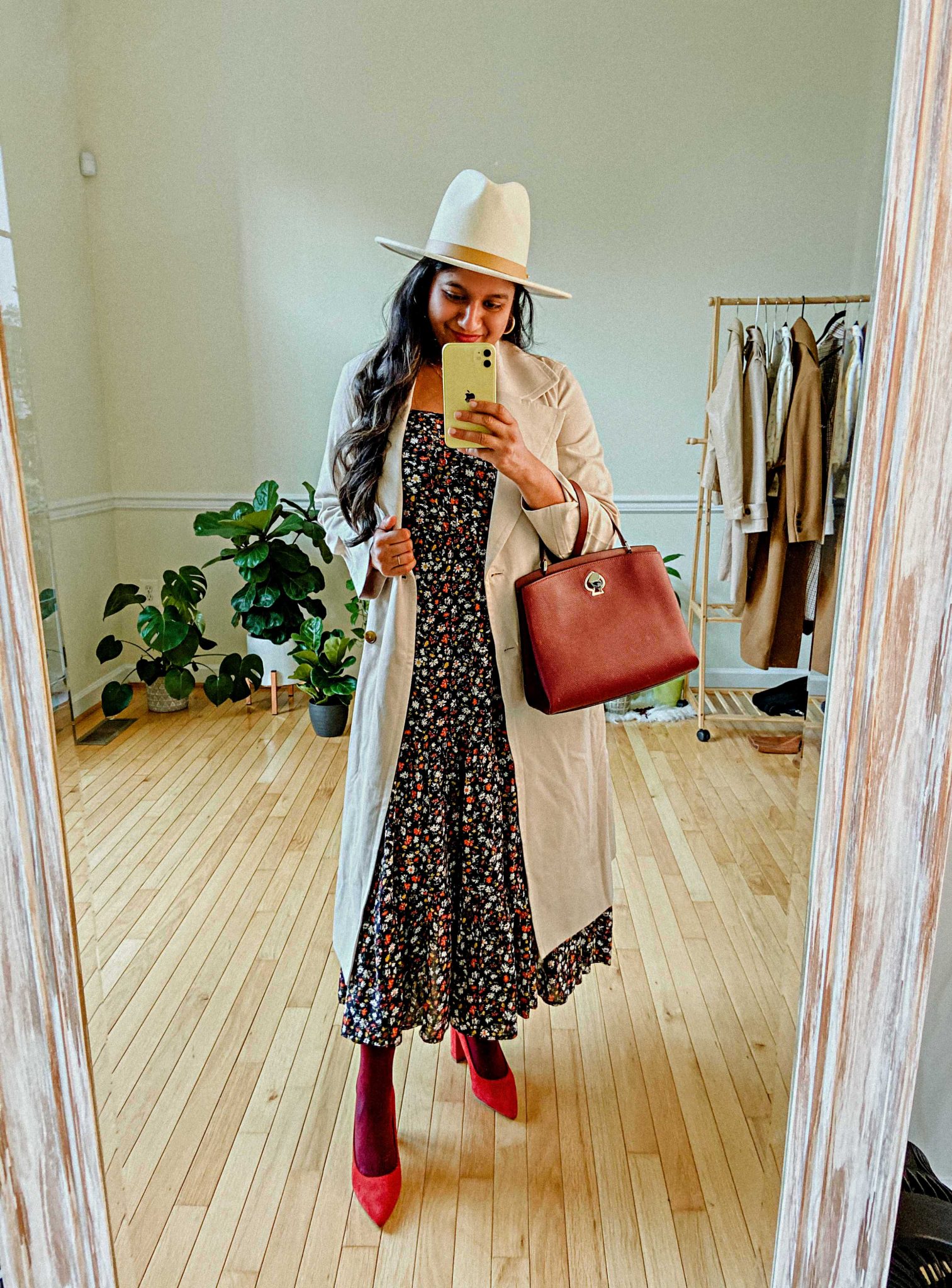 Wearing Ditsy Floral Sleeveless Tiered Midi Dress,Everlane trench coat, Lack of Color Fedora hat, burgundy tights | Summer Dresses by popular Maryland modest fashion blog, Dreaming Loud: image of a woman Wearing Ditsy Floral Sleeveless Tiered Midi Dress, Everlane trench coat, Lack of Color Fedora hat, and burgundy tights.