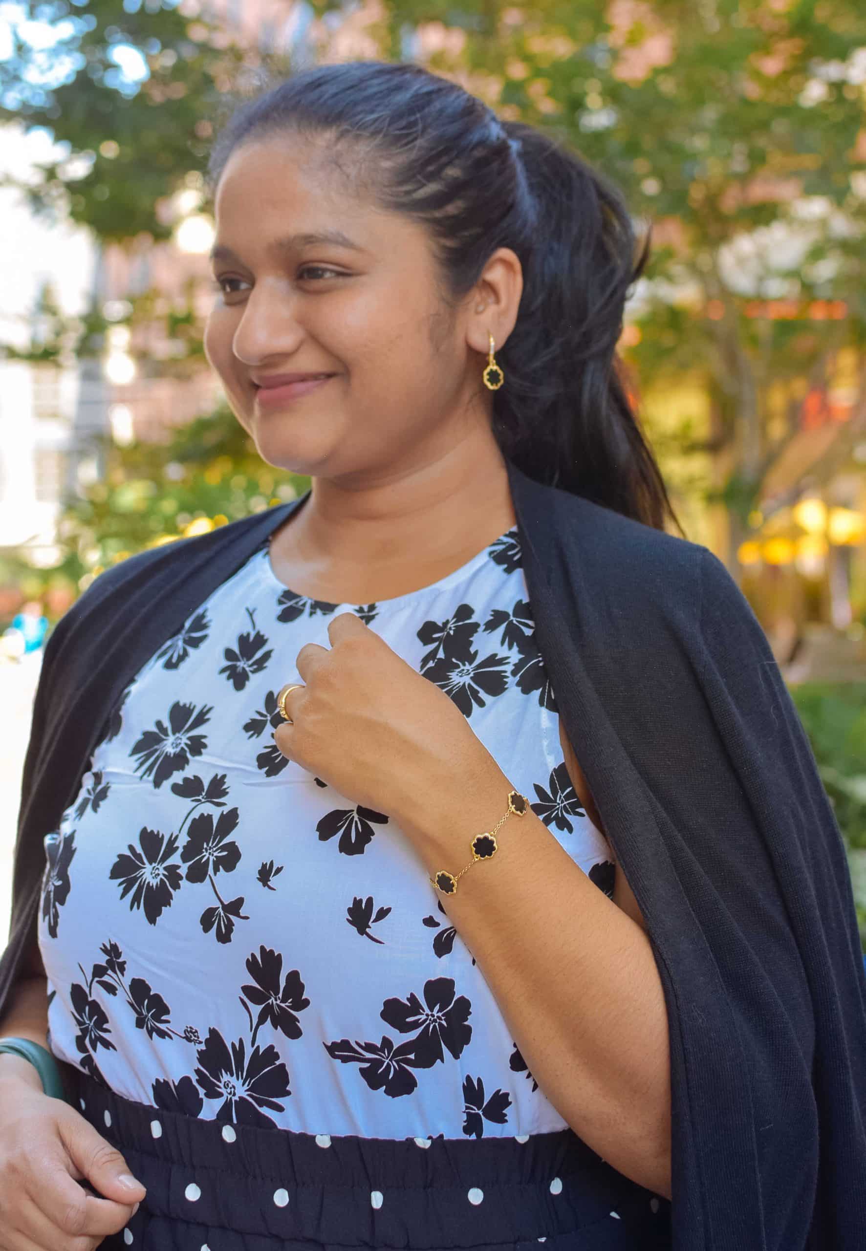 wearing STERLING FOREVER 14K Goldplated & Black Mother-Of-Pearl Clover Station Bracelet,14K Yellow Goldplated & Black Mother-Of-Pearl Clover Earrings