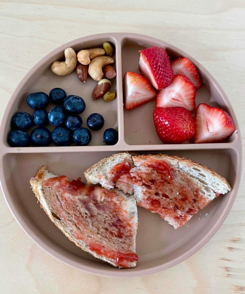 Quick and Healthy Toddler Snack Ideas and Recipes- Almond butter and jelly sandwich with roasted nuts and berries by Top US mom Blogger Dreaming Loud