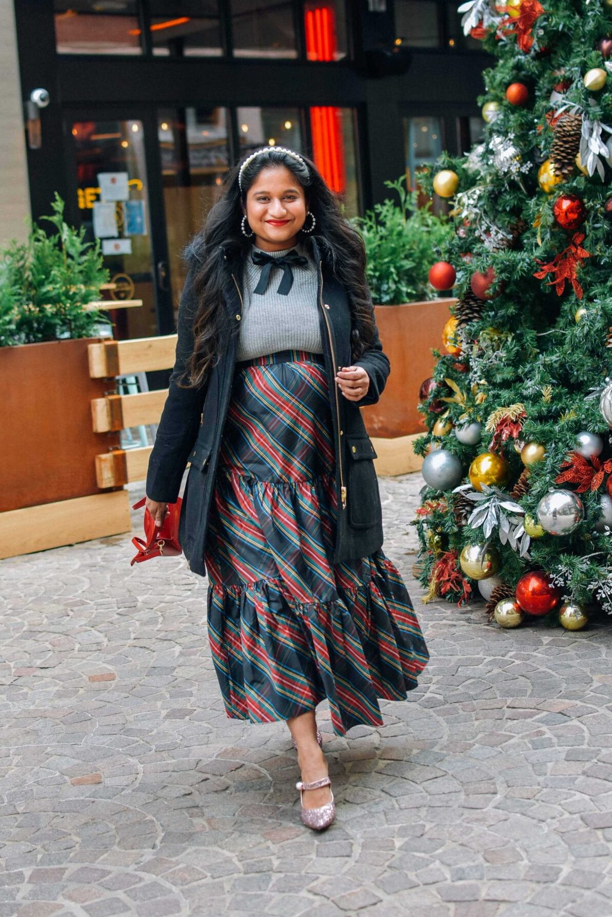 Your Ultimate Guide to What to Wear to A Maternity Shoot-Wearing-J.crew-Chateau-parka-in-Italian-stadium-cloth-wool-in-black-J.crew-Tartan-tiered-sirt-bow-sweater-Pink-sequin-pumps-Holiday-Outfit-ideas by Top US mom Blogger Dreaming Loud